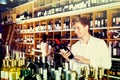 Portrait of glad male customer taking bottle of wine in store