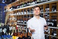 Portrait of glad male customer tasting wine before purchasing it