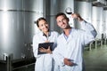 Portrait of glad two experts examining wine
