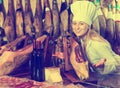 Portrait of glad woman selling prosciutto meat