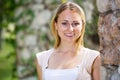 Portrait of glad young blond woman in garden Royalty Free Stock Photo