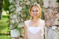 Portrait of glad young blond woman in garden Royalty Free Stock Photo
