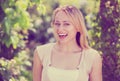 Portrait of glad young blond woman in garden Royalty Free Stock Photo