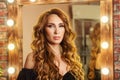 Portrait glam redhead woman with curly hairstyle