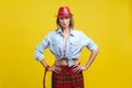 Portrait of glamorous confident woman wearing stylish red hat. studio shot on yellow background