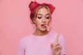 Portrait of glamorous young woman with colored hair stretching chewing gum