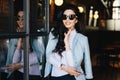 Portrait of glamour young woman with dark wavy hair wearing sung Royalty Free Stock Photo