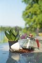 Portrait glass jar with coffee inside and empty cup on the stone table at the outdoor garden Royalty Free Stock Photo