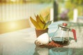 Portrait glass jar with coffee inside and empty cup on the stone table at the outdoor garden Royalty Free Stock Photo