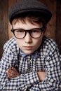 Portrait, glasses and serious kid with arms crossed for fashion, retro or vintage. Confident face, nerd and young boy Royalty Free Stock Photo