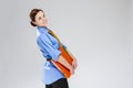 Portrait of Gleeful Caucasian Businesswoman Posing with Colorful Folders In Studio