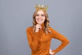 portrait of glory. smiling blonde woman in crown. self confident queen. expressing smug