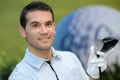 Portrait golfer posing with ball on field