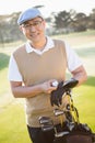 Portrait of golfer posing with his golf equipments