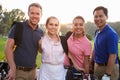 Portrait Of Golfers Walking Along Fairway Carrying Golf Bags Royalty Free Stock Photo