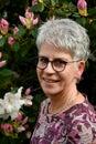 Portrait of a friendly woman standing in her garden Royalty Free Stock Photo