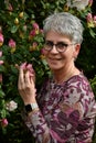 Portrait of a friendly woman standing in her garden Royalty Free Stock Photo