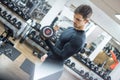 Portrait of good-looking handsome young man lifting weights in gym Royalty Free Stock Photo