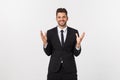 Portrait of good-looking male model expressing surprise and joy raising his hands, isolated over white background. Royalty Free Stock Photo