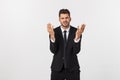 Portrait of good-looking male model expressing surprise and joy raising his hands, isolated over white background. Royalty Free Stock Photo