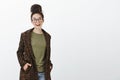 Portrait of good-looking stylish european woman with curly hair and bun haircut, wearing black trendy glasses and Royalty Free Stock Photo