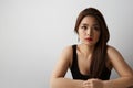 Portrait of gorgeous asian woman with long dark hair looking at camera, isolated over white background in studio Royalty Free Stock Photo