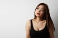 Portrait of gorgeous asian woman with long dark hair looking at camera, isolated over white background in studio. Royalty Free Stock Photo