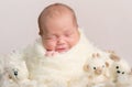 Portrait of gorgeous baby asleep in soft beige wrap