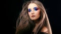 Portrait of a gorgeous beautiful girl with long hair and blue smoky eyes. Royalty Free Stock Photo