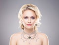 Portrait of gorgeous blond wearing luxury necklace with a gem