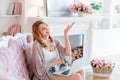 Portrait of gorgeous blonde woman with laptop working at home. Beautiful freelancer female talking in a video conference Royalty Free Stock Photo