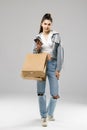 Portrait of gorgeous brunette woman shopping using her smartphone isolated on white Royalty Free Stock Photo