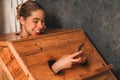 Gorgeous woman playing her mobile phone while using sauna cabinet.Tranquility Royalty Free Stock Photo