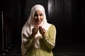 Portrait of a gorgeous humble Muslim woman praying in peace at a mosque