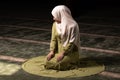 Portrait of a gorgeous humble Muslim woman praying in peace at a mosque