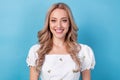 Portrait of gorgeous nice young woman blonde curls wearing crop top white blouse smiling stylish model isolated on blue Royalty Free Stock Photo