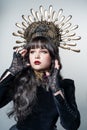 Portrait of a gorgeous young girl with beautiful makeup in an elegant headdress, golden crown.The face of a queen with long, black Royalty Free Stock Photo