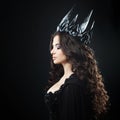 Portrait of a Gothic Princess. Beautiful young brunette woman in metal crown and black cloak. Royalty Free Stock Photo