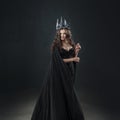 Portrait of a Gothic Princess. Beautiful young brunette woman in metal crown and black cloak. Royalty Free Stock Photo