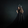 Portrait of a Gothic Princess. Beautiful young brunette woman in metal crown and black cloak. Royalty Free Stock Photo