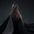 Portrait of a Gothic Princess. Beautiful young brunette woman in metal crown and black cloak. Royalty Free Stock Photo
