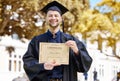 Portrait, graduate and holding certificate with man in with campus for achievement. Diploma, guy and happy face with Royalty Free Stock Photo