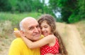 Portrait of granddad and granddaughter smiling at the park Royalty Free Stock Photo