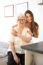 Portrait of granddaughter behind her grandmother at home Royalty Free Stock Photo