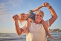 Portrait of Grandfather carrying his granddaughter on his shoulders while walking along the beach. Adorable little girl Royalty Free Stock Photo