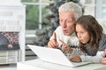 Portrait of grandfather and child with laptop