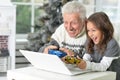 Portrait of grandfather and child with laptop