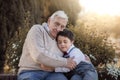 Portrait of grandfather and grandson embracing