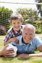 Portrait Of Grandfather And Grandson With Football