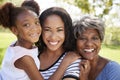 Portrait Of Grandmother With Adult Daughter And Granddaughter Relaxing In Park Royalty Free Stock Photo